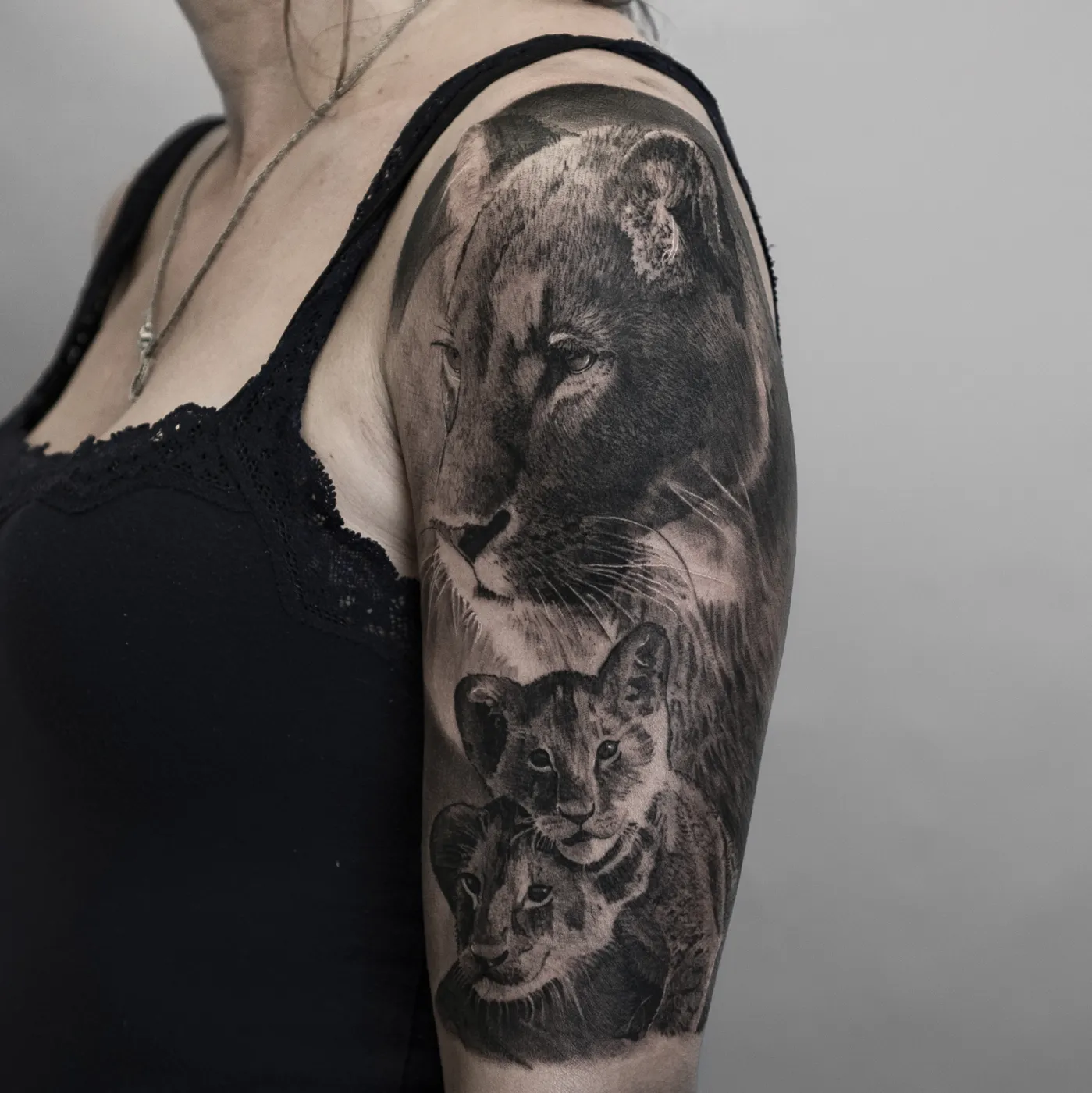 Tatuaje realista de leona con cachorros en el brazo, Motink Pallejà